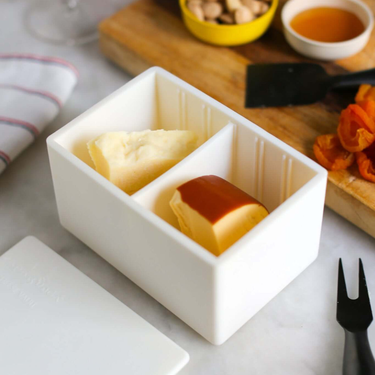 CapaBunga Cheese Vault storing different cheese types with accompaniments on a marble surface.