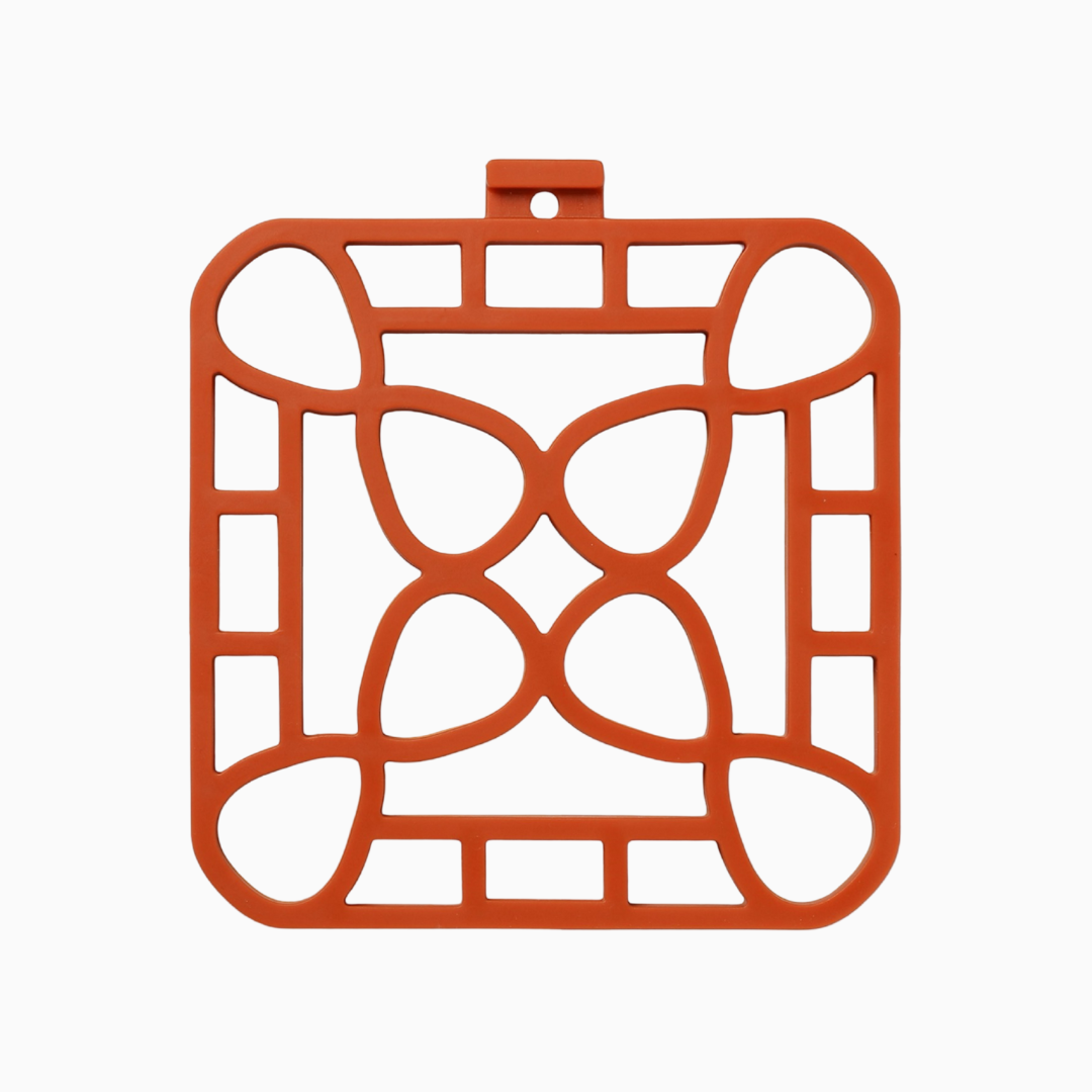Interlocking silicone trivet in orange color, designed for heat-resistance and stylish serving.