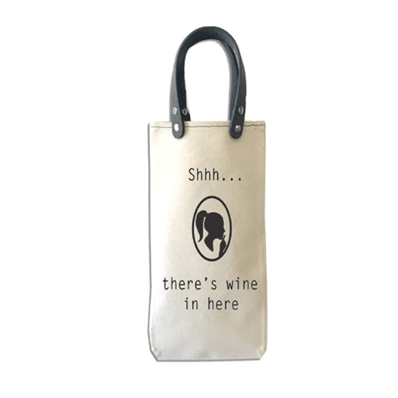 Shh There Is Wine Canvas Wine Tote with vegan leather handles for carrying wine bottles.