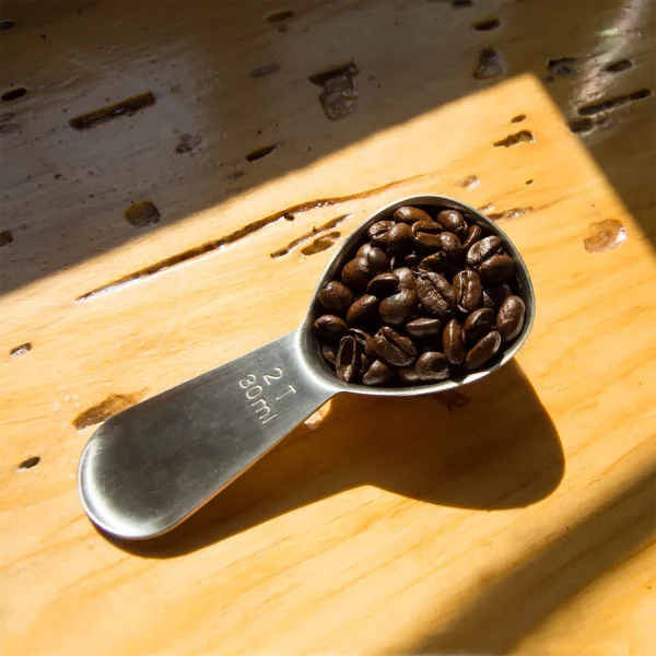 A coffee spoon on a table in the sunlight