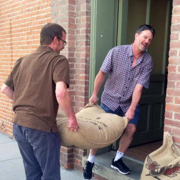 People carrying large bag of coffee