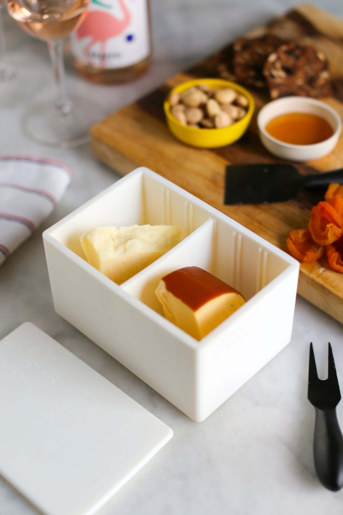 CapaBunga Cheese Vault storing different cheese types with accompaniments on a marble surface.