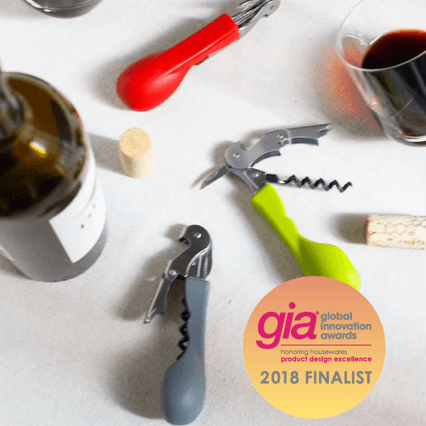 Silicone handled corkscrews by CapaBunga in red, black, and green with wine glasses and a bottle.
