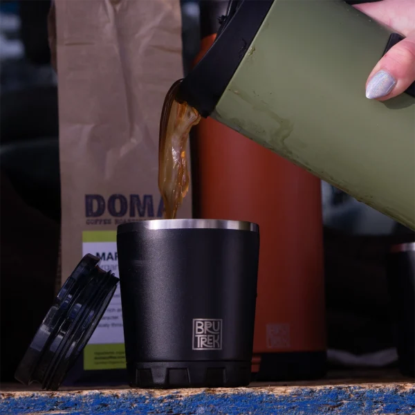 Person pouring coffee into the Camp Cup