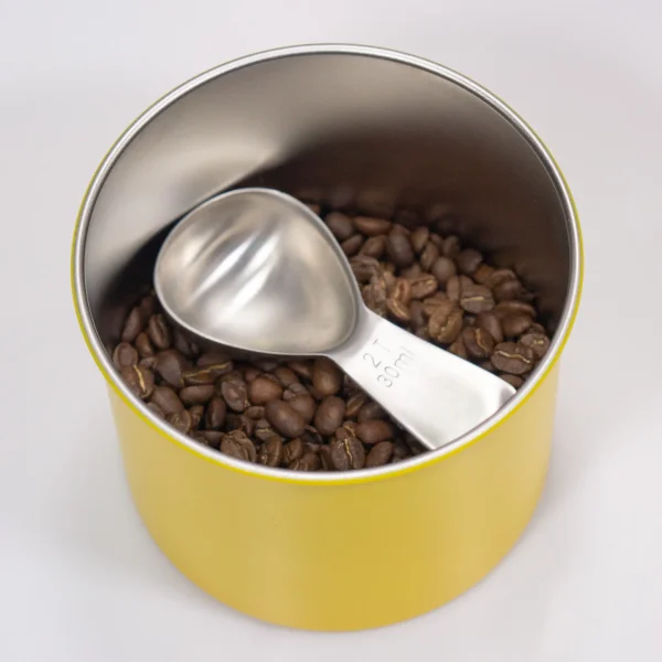 A coffee Spoon inside a coffee container