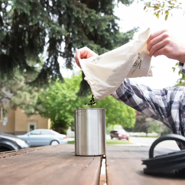 pouring coffee into airscape coffee container
