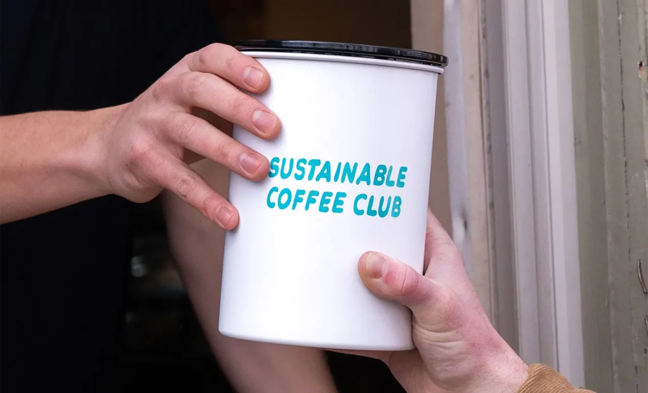 Sustainable Coffee Club Coffee Container being handed off between two people