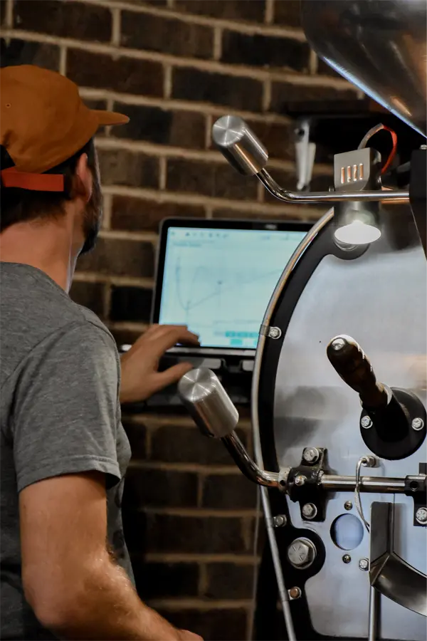 Coffee Roaster Adjusting Setting on Coffee Roasting Machine