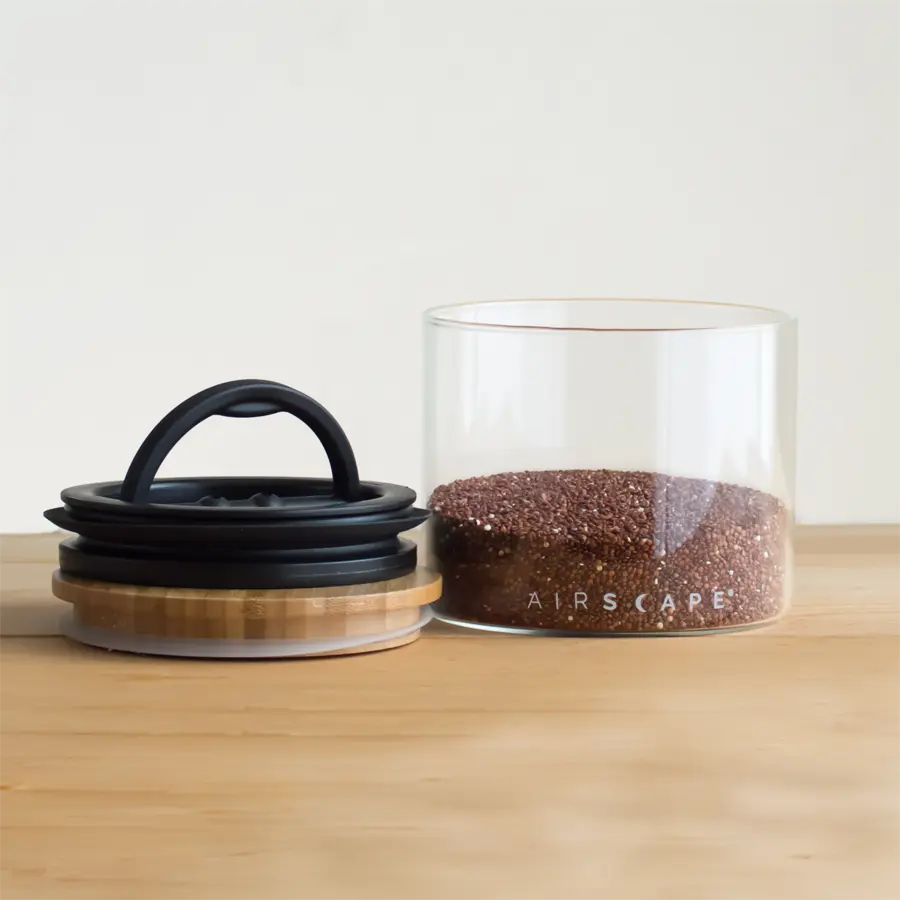 glass coffee jar on wooden counter